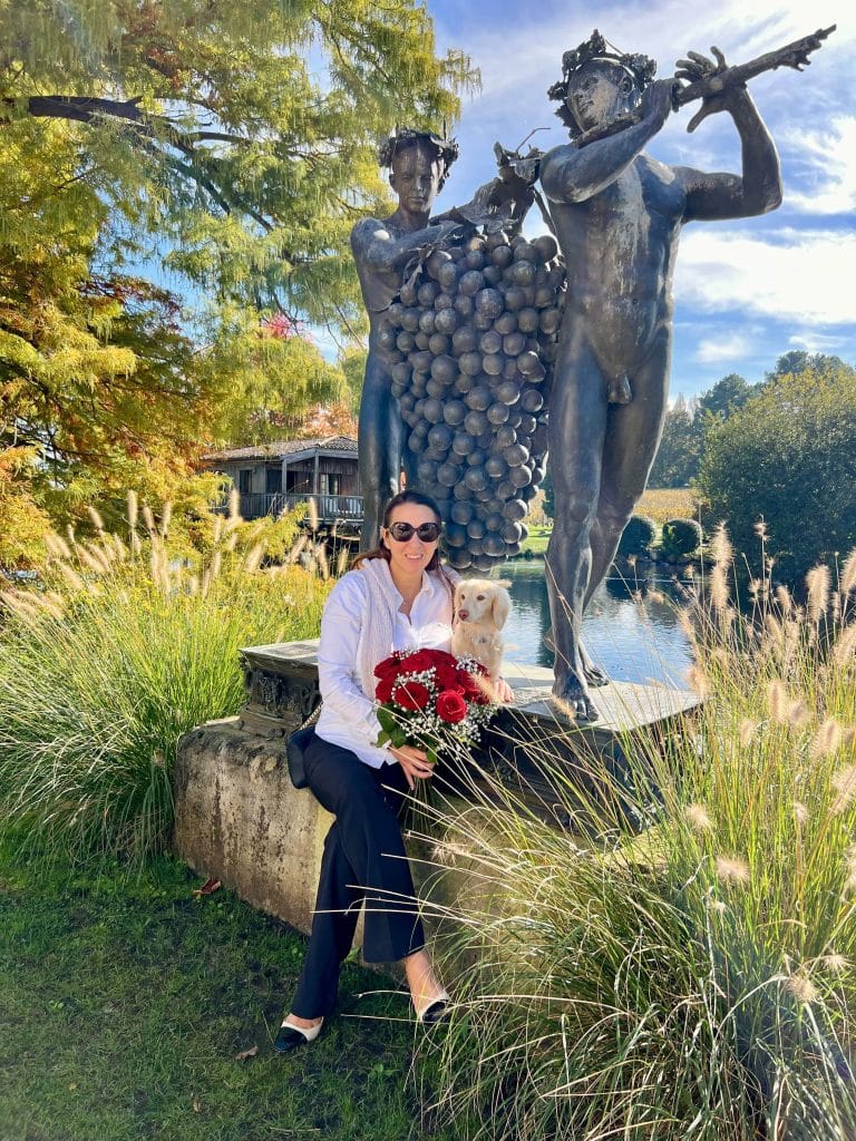 Women with cream dachshund enjoying a luxury retreat at Caudalie, elegant travel and lifestyle moment from The Suite Spot.