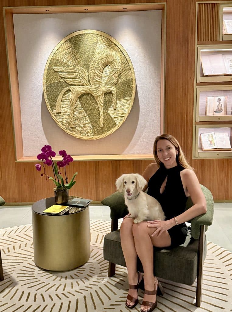 Elegant women with her dachshund in a luxury Business Lounge for a first class travel experience.