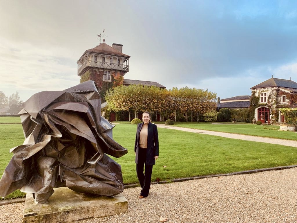 Woman admiring contemporary artwork near Château Smith Haut Lafitte at Les Sources de Caudalie.